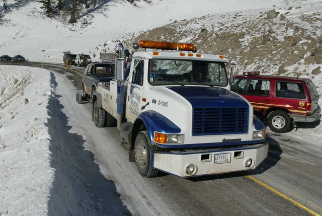 Tow truck towing damaged SUV east of Phantom Lake Picture