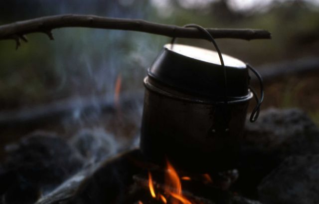 Cooking pot over fire at backcountry campsite Picture