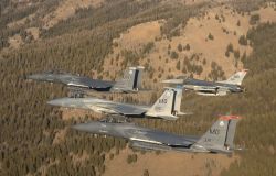 Two F-15 Strike Eagles, an F-15 Eagle and an F-16 Fighting Falcon - A Four-ship formation - Mountain Home Air Force Base - Flying over Idaho Photo