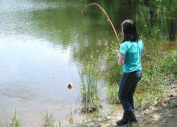 Young girl catching bluegill at Occoquan Bay NWR Photo