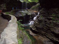 Stream, waterfall, pools, and lush green foliage at Watkins Glen State Park. Image