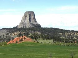 Devils Tower seen above an irrigated field Image