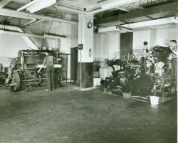 A Harris press to the right and the Seybold-Harris guillotine paper cutter to the left Image