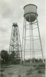 A large wooden tower on an Arizona Station next to a water tank Image