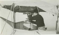 Floyd Risvold observing angles with theodolite No Image