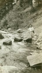 Floyd Risvold fishing at brink of Tower Falls, Yellowstone National Park. Image