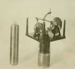 Portable tide gauge mounted on float well showing float. Image