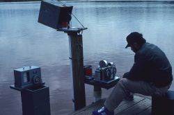 Ensign Marty Conricote checking an ADR water-level gauge on Lake Superior Image