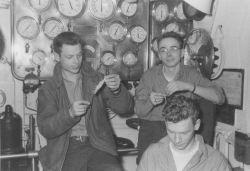 Eating shrimp in the engine room in front of the Bailey Board. Image