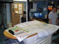 Monitoring survey data on array of computer screens. Image