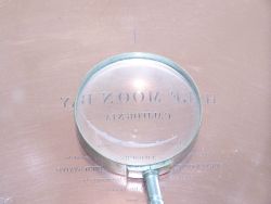 Magnifying glass showing detail of copper plate engraving of mid-Nineteenth Century chart of Half Moon Bay, California. Image