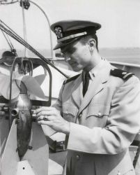 Ensign George Maul inspecting Roberts Radio Current Meter on board USC&GS Ship EXPLORER. Image
