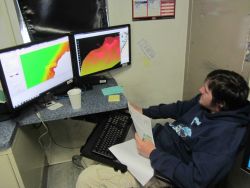 Mark Bradley, hydrographic survey technician, using 3D imagery to confirm uncharted rock in navigational waters Image