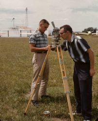 Surveyor taking sun azimuth for true direction to determine magnetic declination from magnetic observations. Image