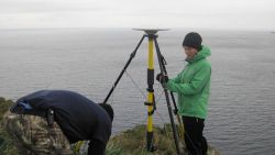 Securing GPS satellite receiver unit on a windswept promontory. Image