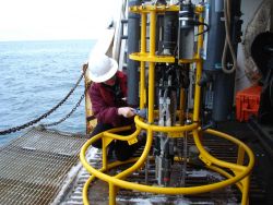 Obtaining water sample from CTD water sampling bottle. Image