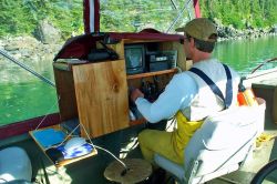 Working at the ROV control station during a high-tech skiff survey. Image