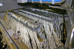A commercial longline rack rigged with commercial gear ready to be baited on a commercial fishing vessel in the Gulf of Alaska. Image