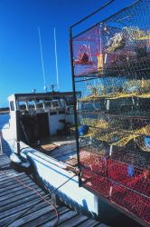 A blue crab fishing boat loaded with pots and ready to go to work. Image
