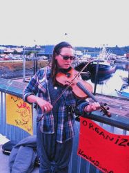 A violinist plays at the community fish fry in support of the United Seiners Association Image
