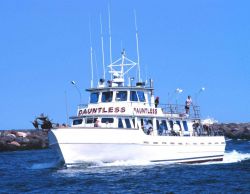 A recreational fishing boat enters Manasquan Inlet after a day of fishing. Image