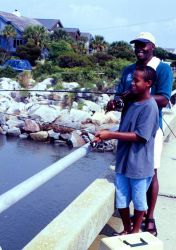 A man and his son visiting from Ohio try their luck at bridge fishing near Charleston, South Carolina Image