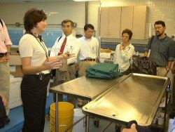 Epcot Living Seas Aquarist, Jane Davis, discusses health procedures in the veterinary laboratory while Dr Image