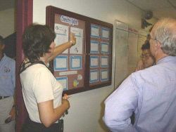 Epcot Living Seas Aquarist, Jane Davis shows bulletin board where chemistry data for the aquarium is kept. Image