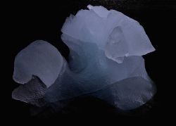 Ice that has been shaped by lapping waves . Image