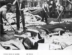 Cutting strips of blubber after a whale is brought to a shore processing facility Image