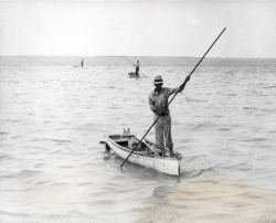 Sponge hooker working in shallow water in Florida Keys. Image