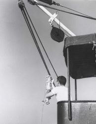 Attaching Nansen bottle to cable on hydrographic cast. Image