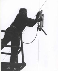 Deploying a Nansen bottle, used for measuring sub-surface temperature and to collect water samples for analysis. Image