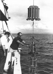 Deploying an early model STD or CTD instrument with water sample bottles above. Image
