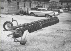 A harrow adapted for underwater use to cover oyster drills and other enemies of commercial mollusks with a layer of bottom deposit Image