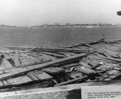 Main dock damaged at Woods Hole BCF Biological Laboratory by Hurricane Carol. Image
