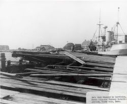Main dock damaged at Woods Hole BCF Biological Laboratory by Hurricane Carol. Image