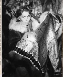 Emma Willoya, who operated a sewing coop, producing a seal skin, fur-trimmed parka. Image