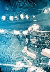 Dredged channel with apparent man-made islands from dredge spoils. Image