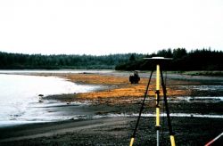 GPS antenna and tripod on beach. Image