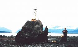 GPS antenna and tripod set up over tidal bench mark on rock Image