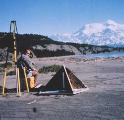 Mike Aslaksen setting up GPS antenna over radar reflector which was used for controlling airborne synthetic aperture radar survey Image