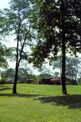 G-19 building trucks with backhoe for digging. Image