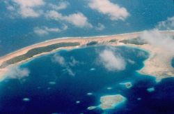 Pacific atoll with inner lagoon showing coral heads. Image