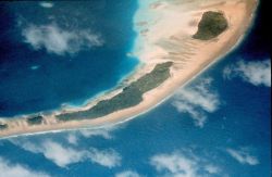 Pacific atoll with inner lagoon showing coral heads. Image