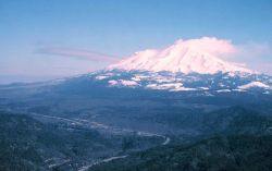 Mount Shasta, one of the great stratovolcanoes of the Pacific Ring of Fire, looms over small town on Interstate 5. Image