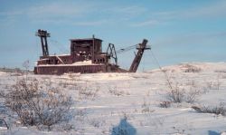 An old gold dredge west of Nome. Image