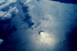 Molokini Island, a crescent island, is rim of volcanic crater opening to north Shore of Kahoolawe is visible in upper right Image