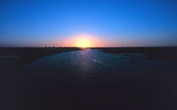 A sunset over coastal waters near Charleston. Image