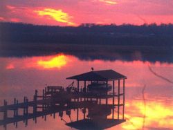 Patuxent River sunset with reflections on a calm river. Image